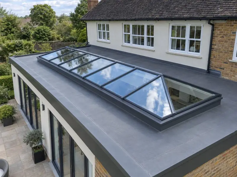 Long made-to-measure roof lantern along a wide flat-roofed extension